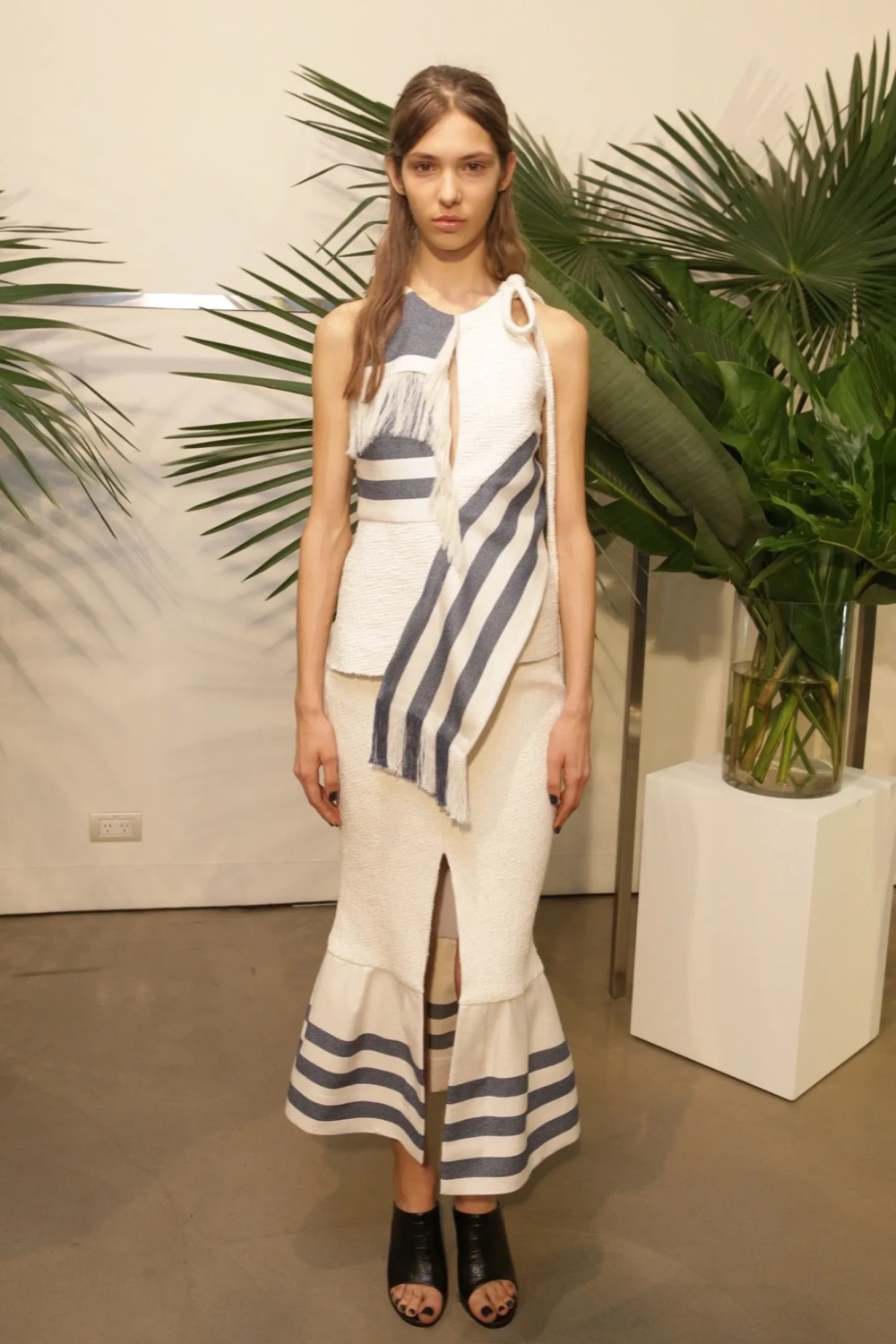 Cream textured top and flared skirt with navy striped fringed sash